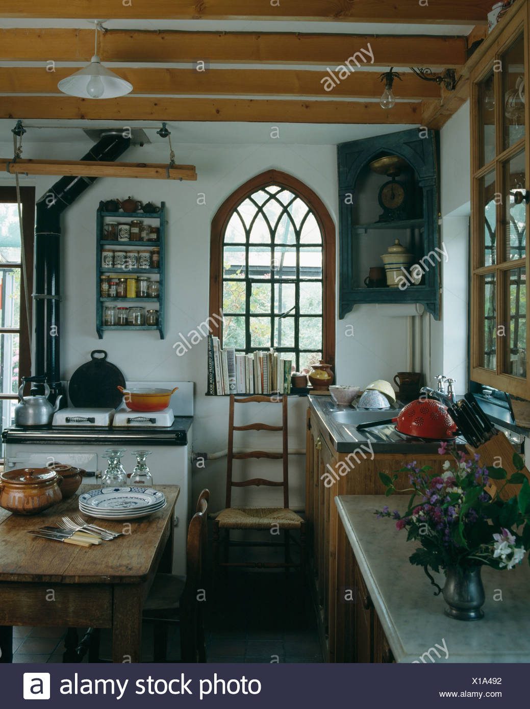 Antique Corner Cupboard Beside Arched Gothic Window In Country