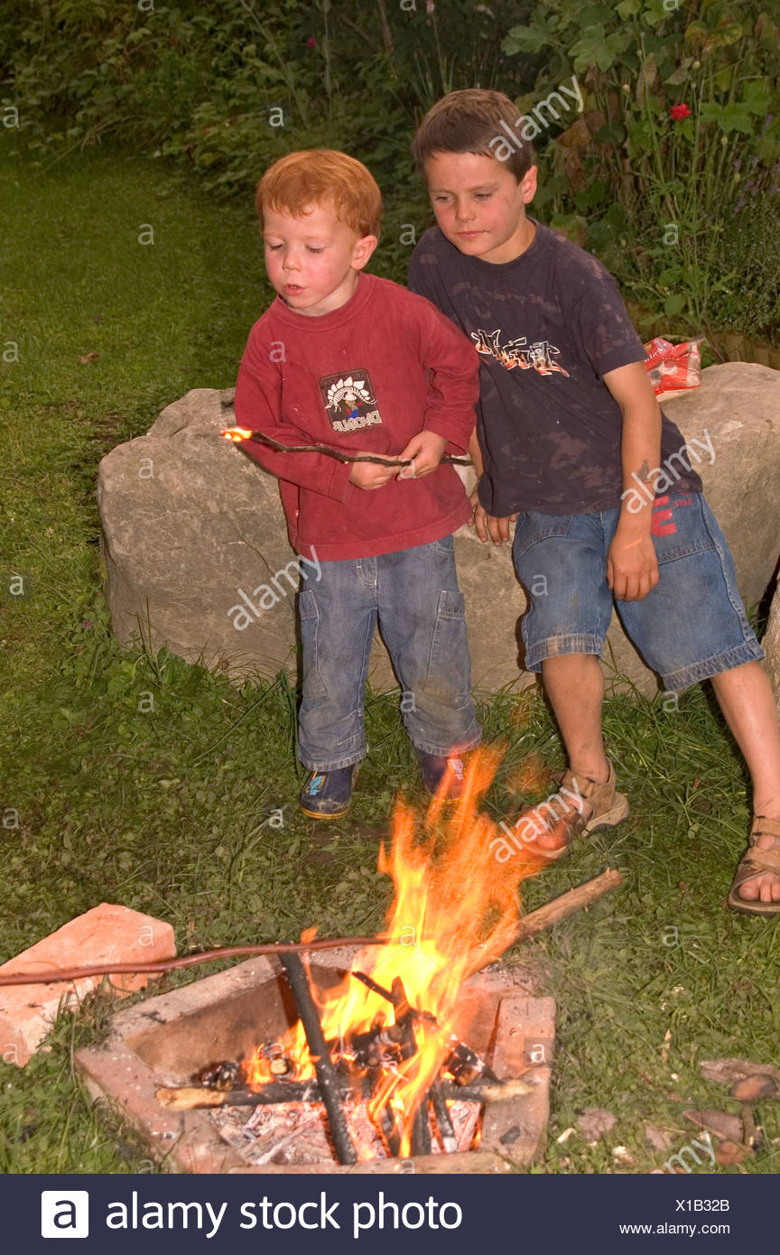 Mr Children Having A Barbecue At An Open Fire Place Campfire Game With Fire Stock Photo Alamy Mr Children Having A Barbecue At An Open Fire Place Campfire Game With Fire Stock Photo Alamy