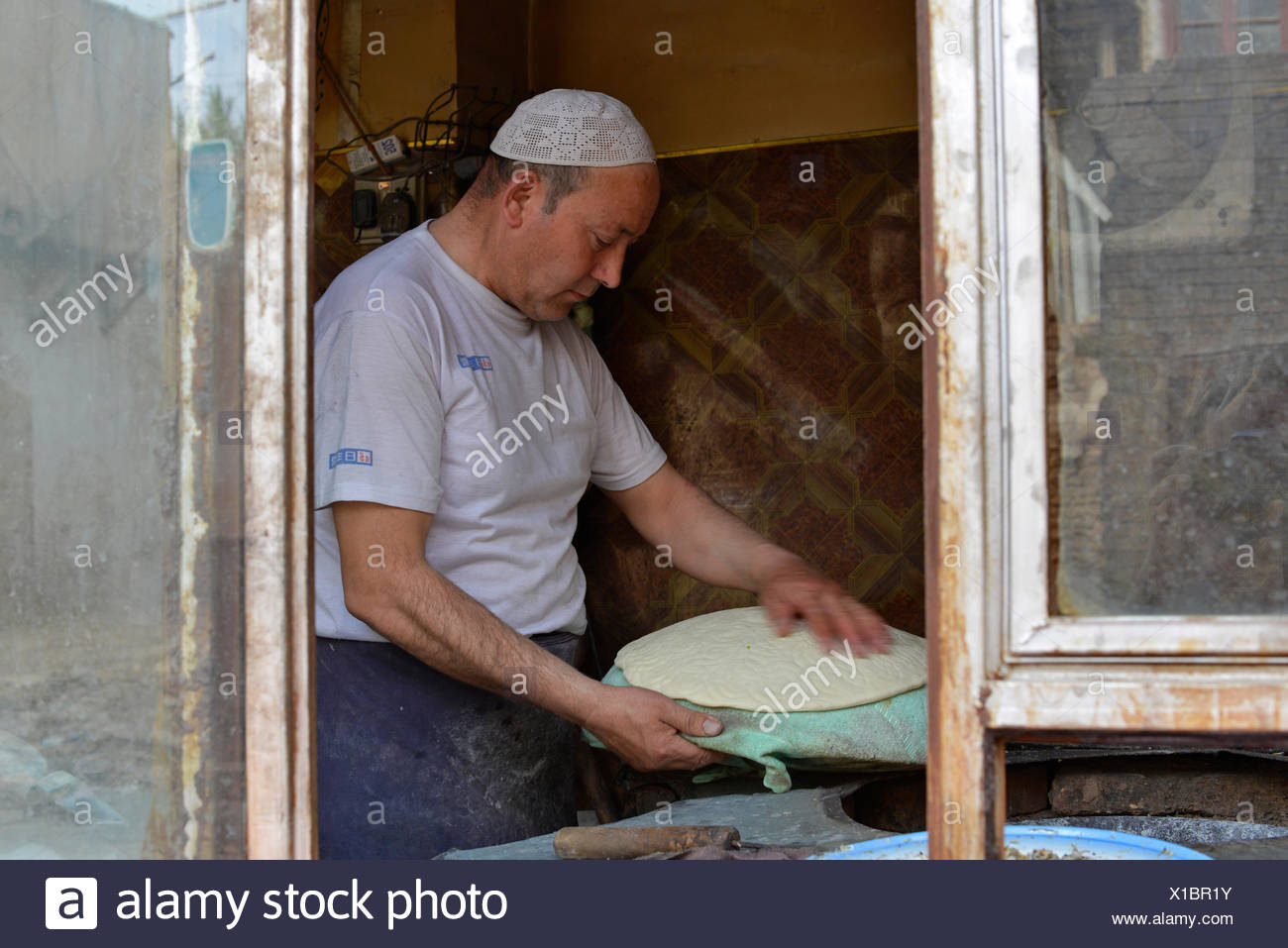 Flatbread Baker In A Bakery Uyghur Muslim Quarter Kashgar