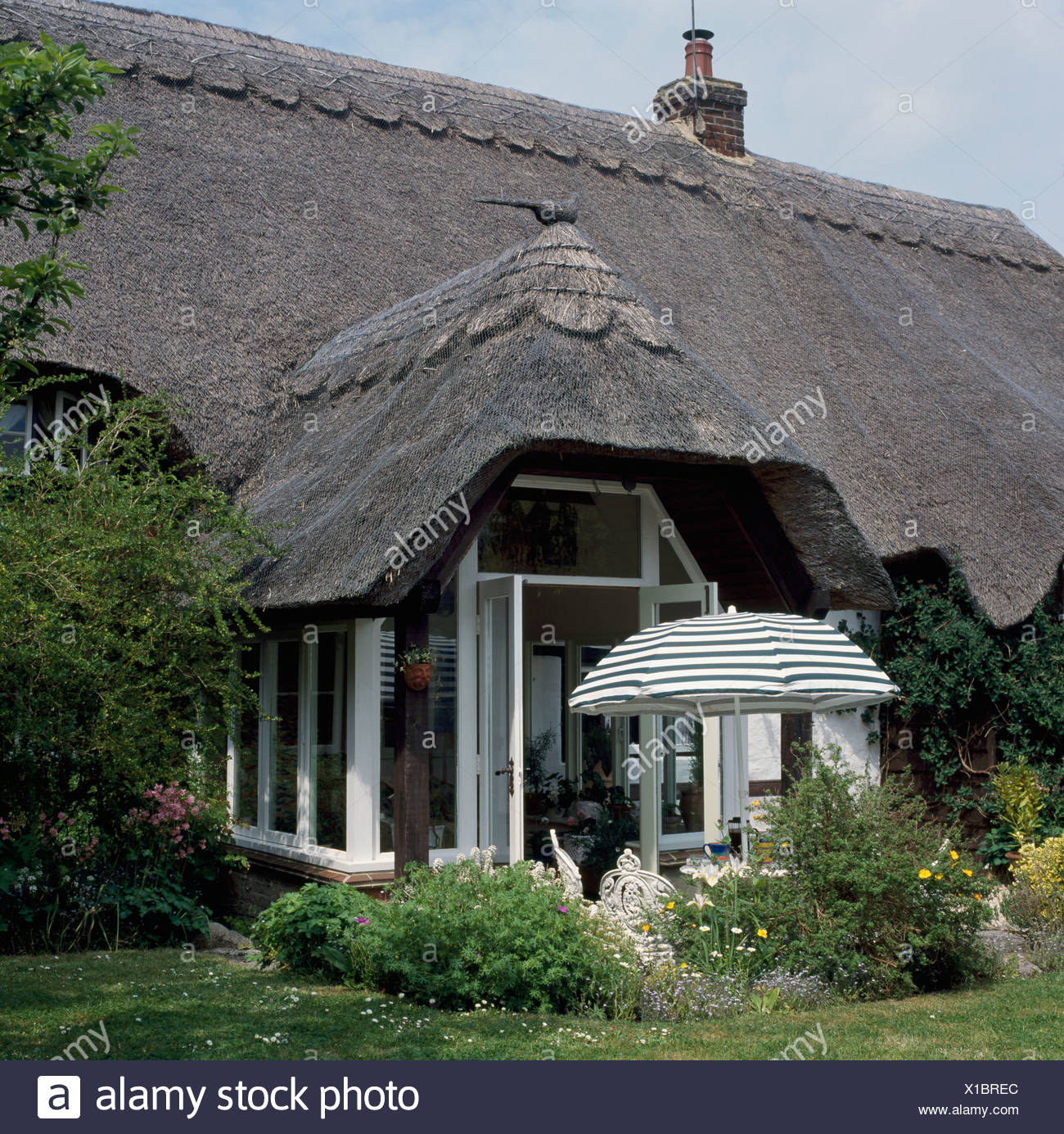 White Thatched Cottage With Thatched Conservatory Extension And