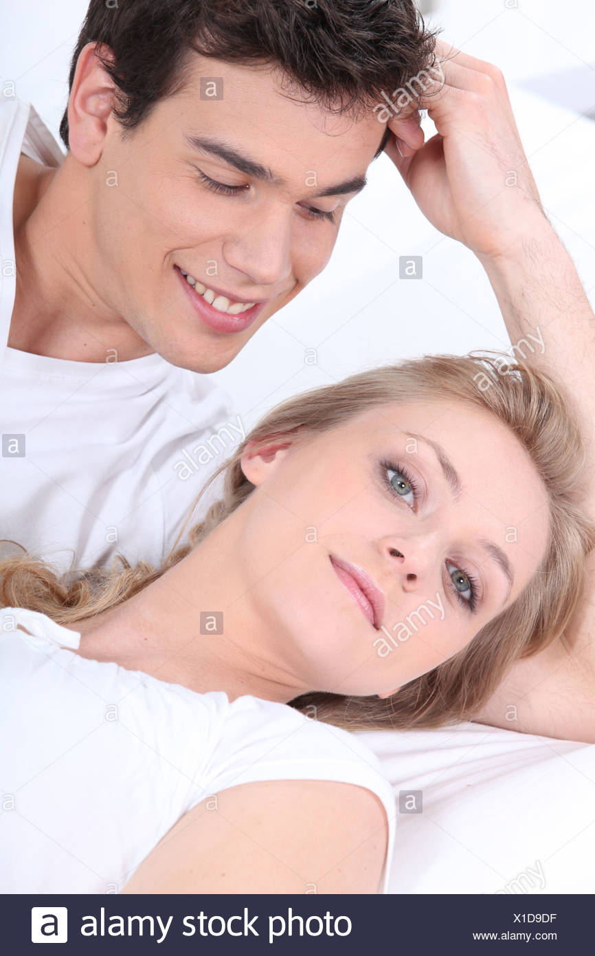 Young Woman And Young Man Laid On A Couch Stock Photo 276273355