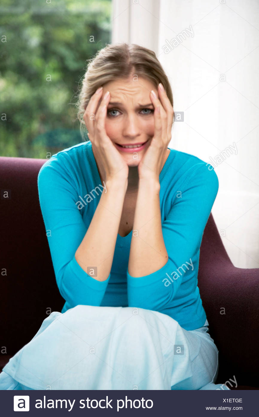 Female Blonde Hair Off Face Wearing Turqois V Neck Jumper And
