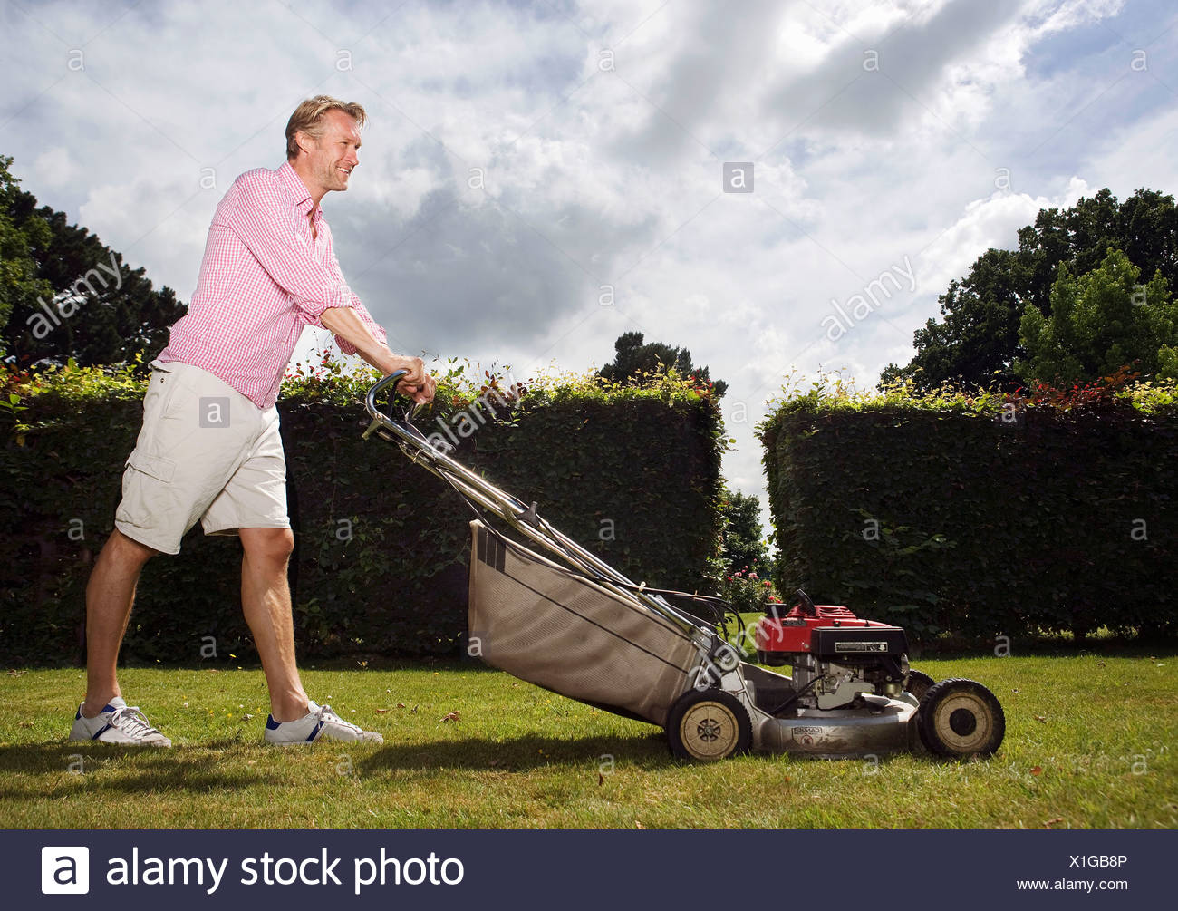 Man Pushing Lawnmower Stock Photos & Man Pushing Lawnmower Stock Images