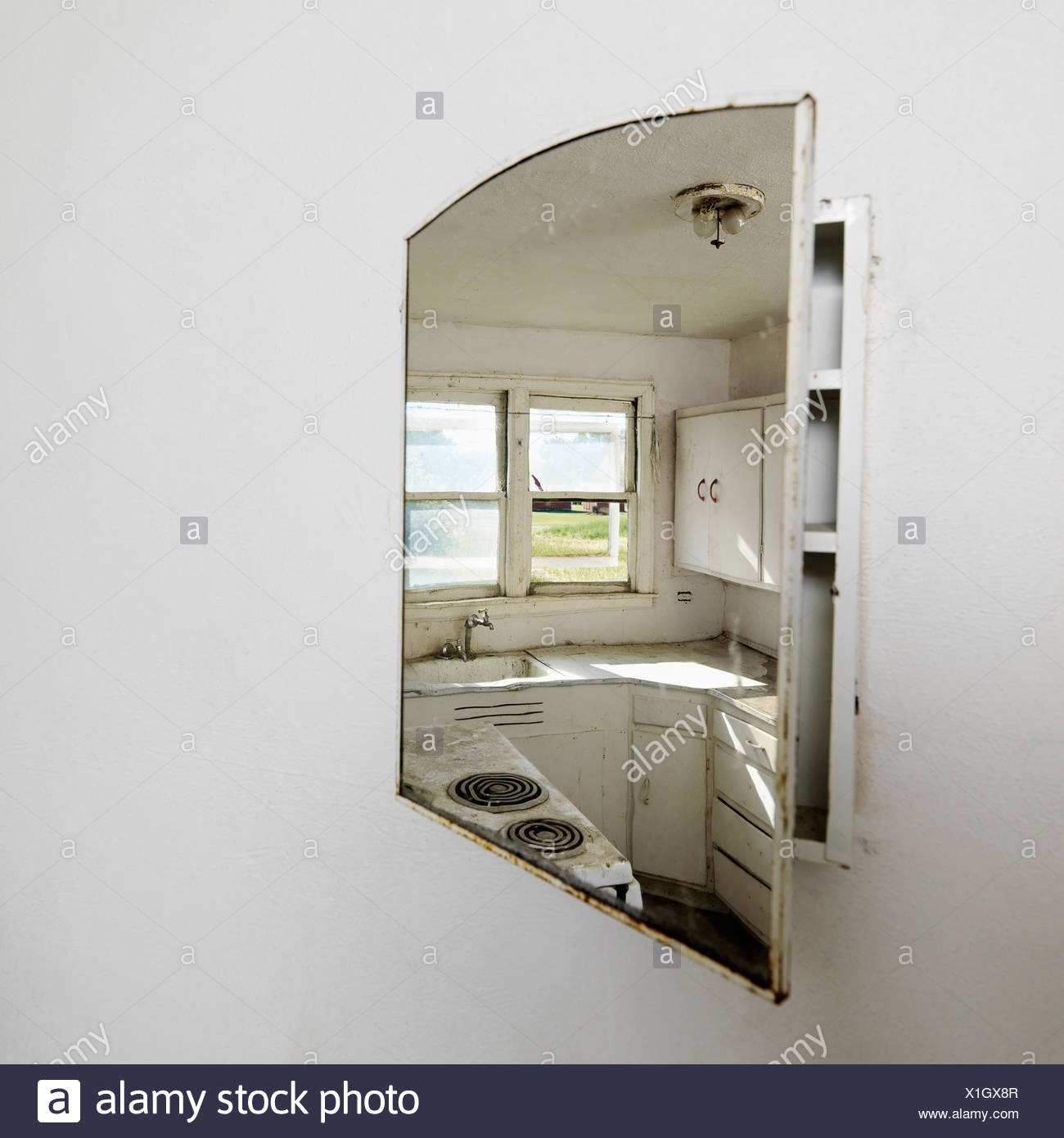 Reflection Of Empty Abandoned Dirty Kitchen In Mirror Stock Photo