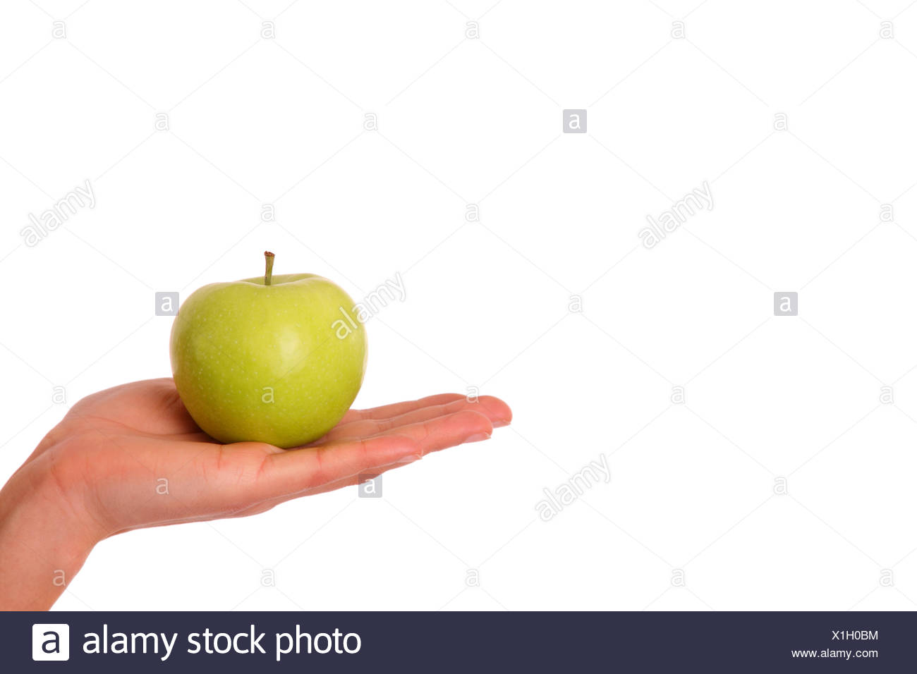 green apple in woman's hand Stock Photo