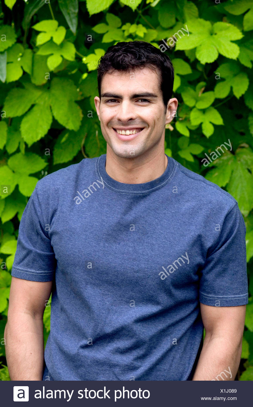 Male With Short Dark Hair Wearing Blue T Shirt Standing