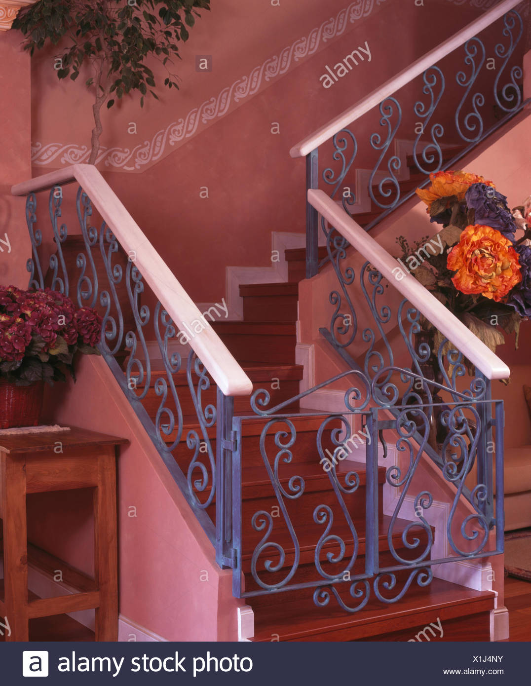 Blue Wrought Iron Banisters And Gate On Wooden Staircase In