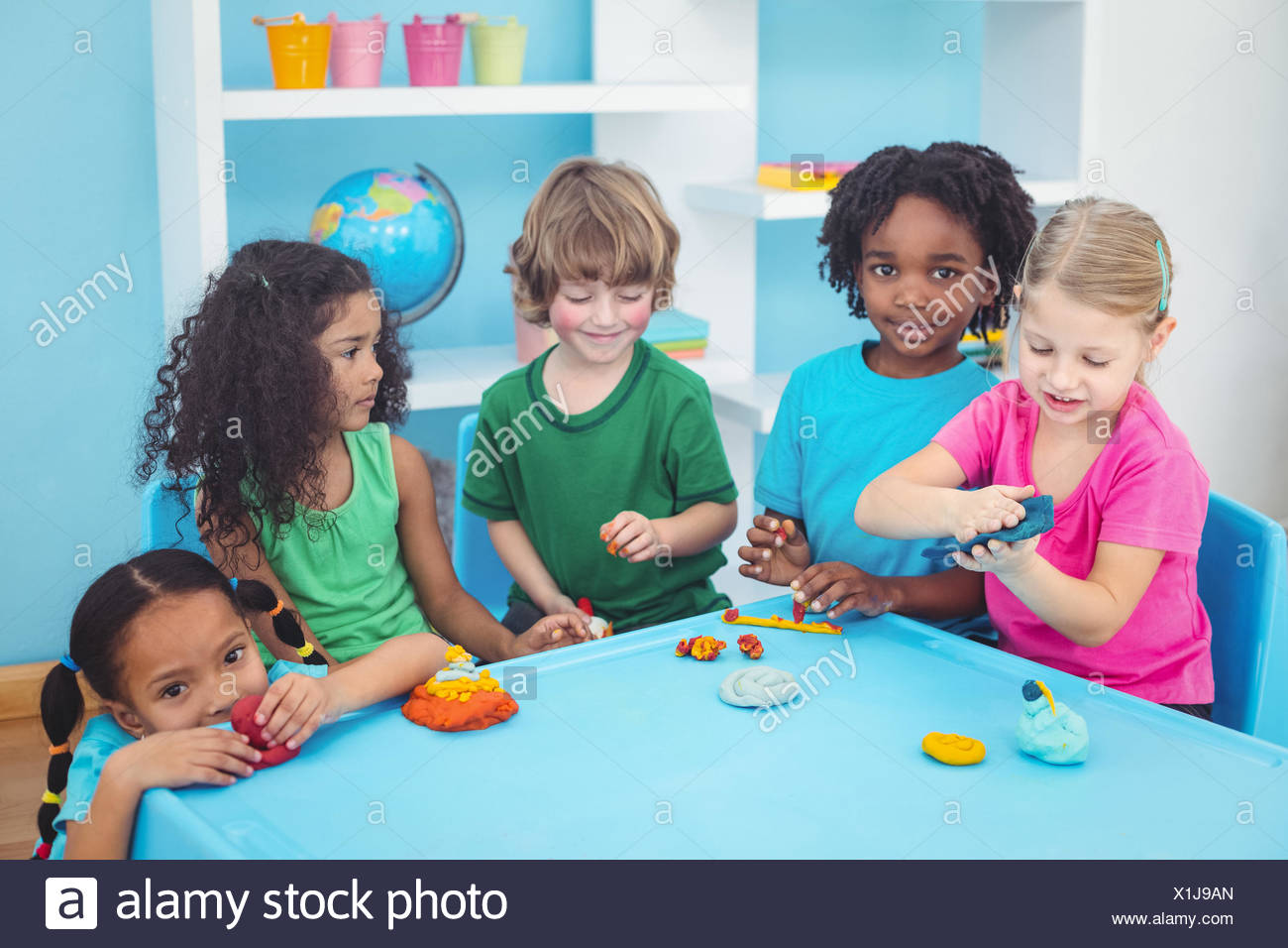 Smiling Kids Playing With Modelling Clay Stock Photo