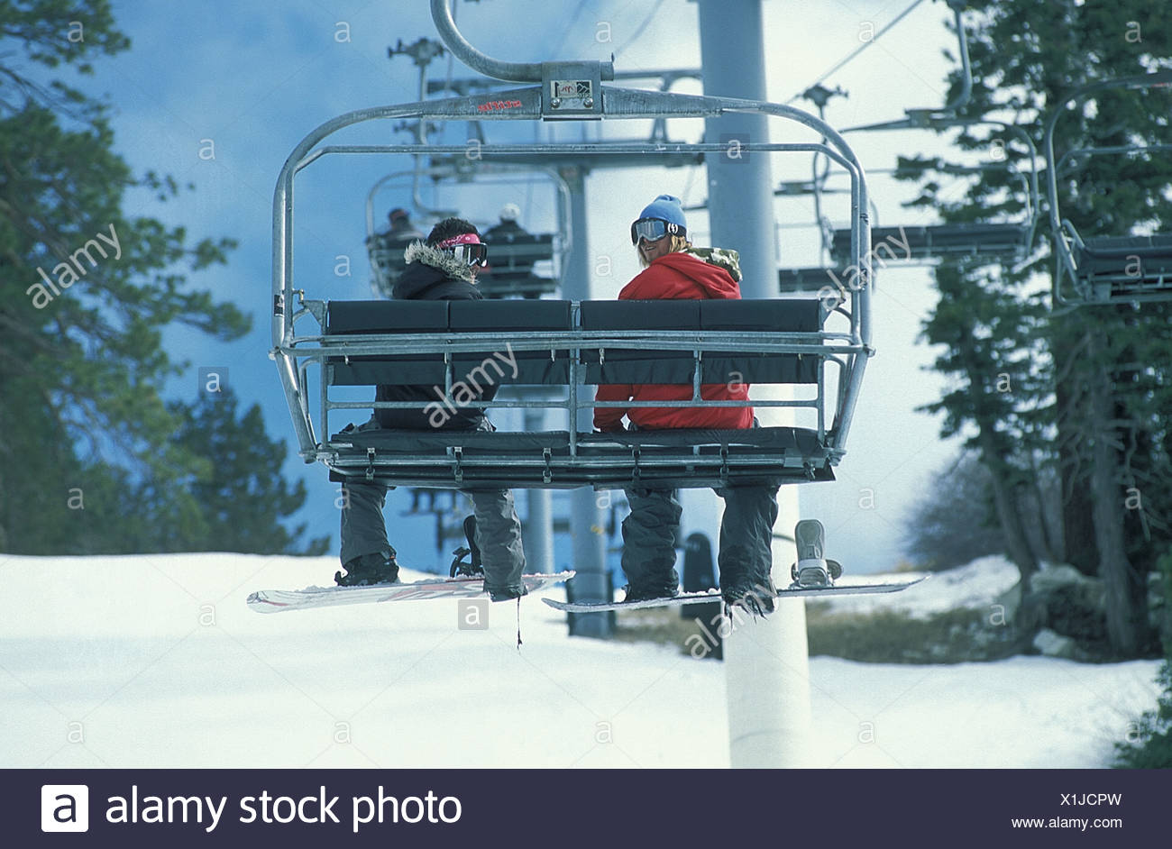 Snowboarders On Chair Lift Big Bear California Stock Photo