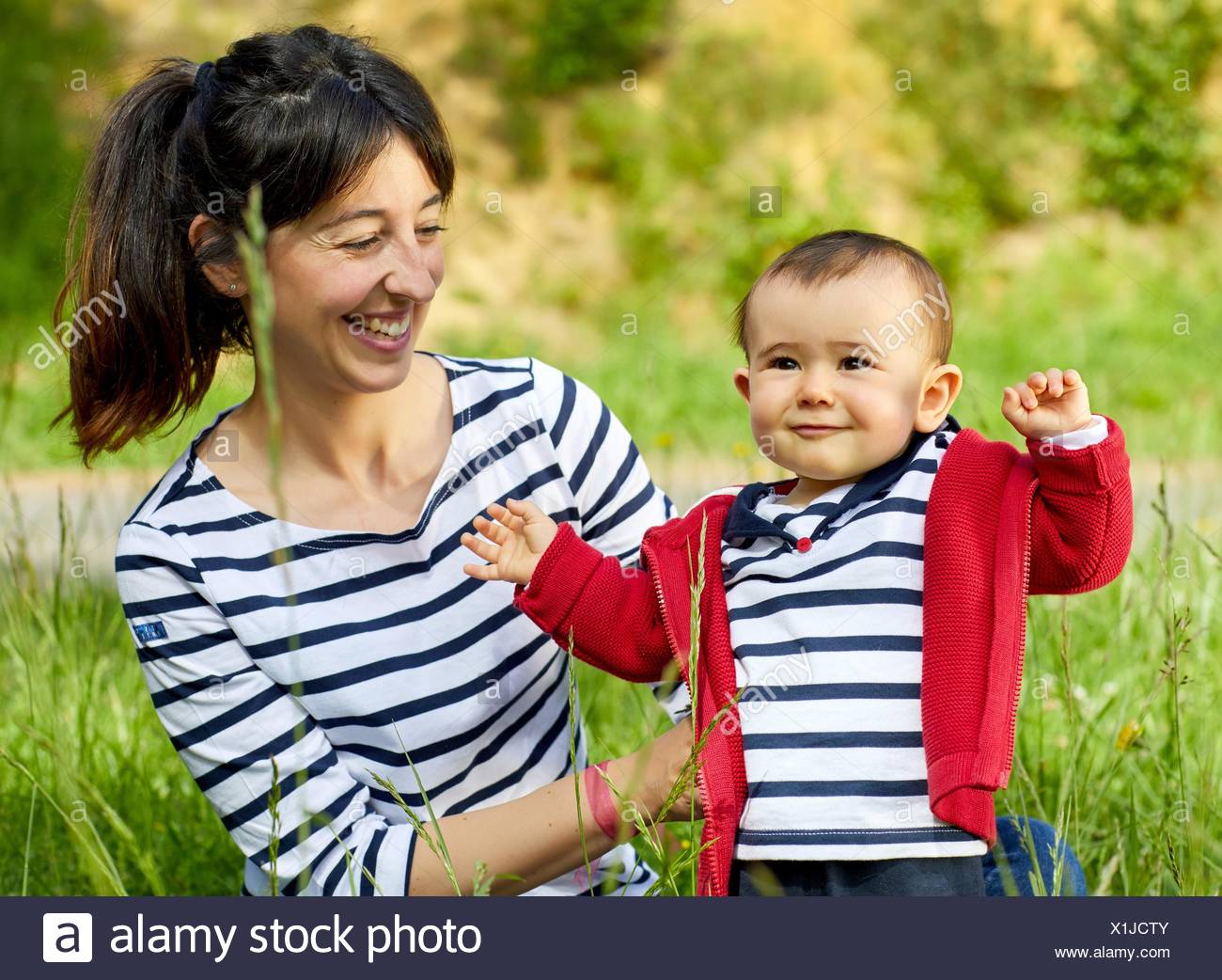 Mother and baby in the park, Getaria, Gipuzkoa, Basque Country, Spain Stock Photo