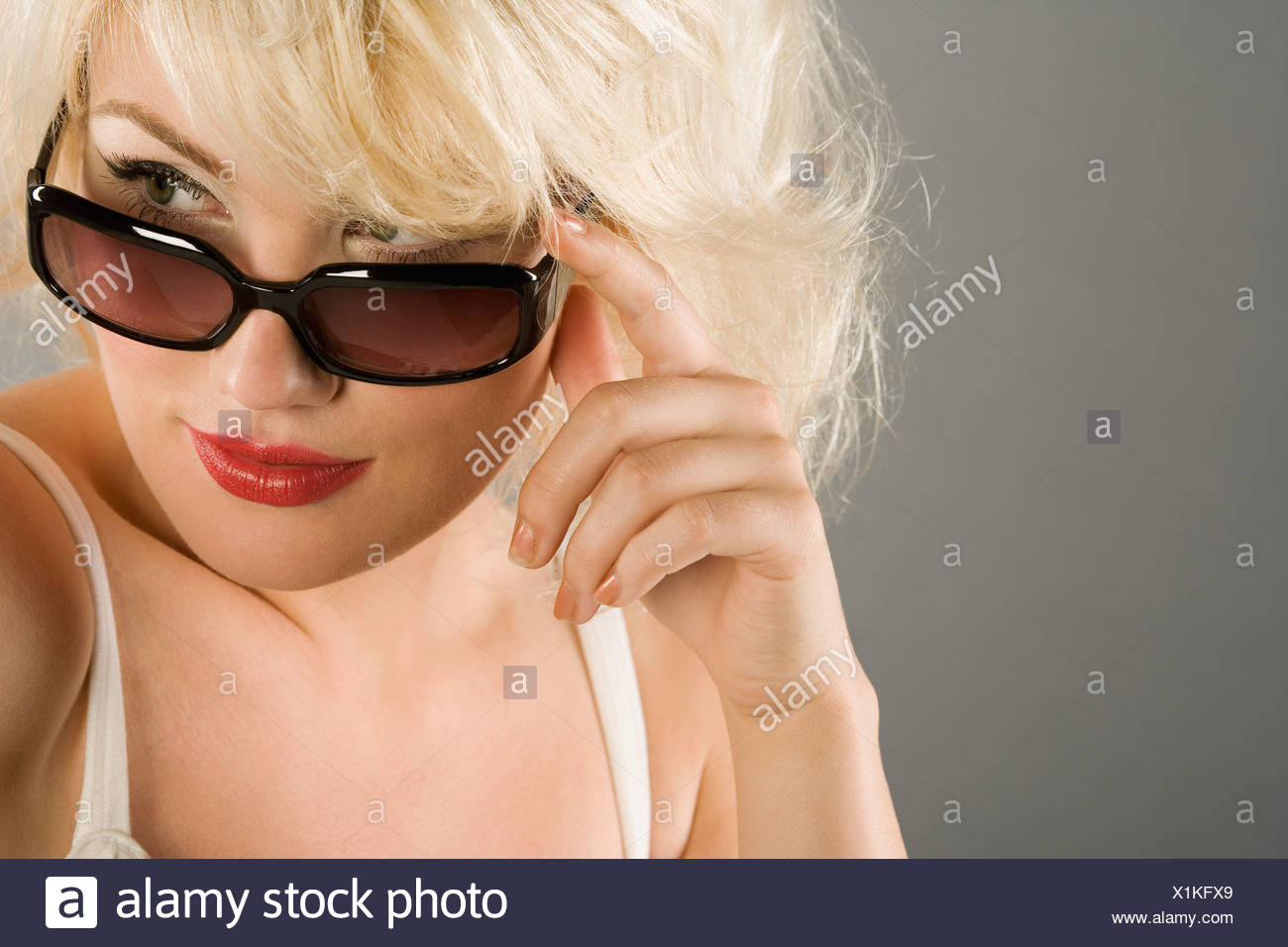 Woman Looking Over Sunglasses Stock Photo Alamy Woman Looking Over Sunglasses Stock Photo Alamy