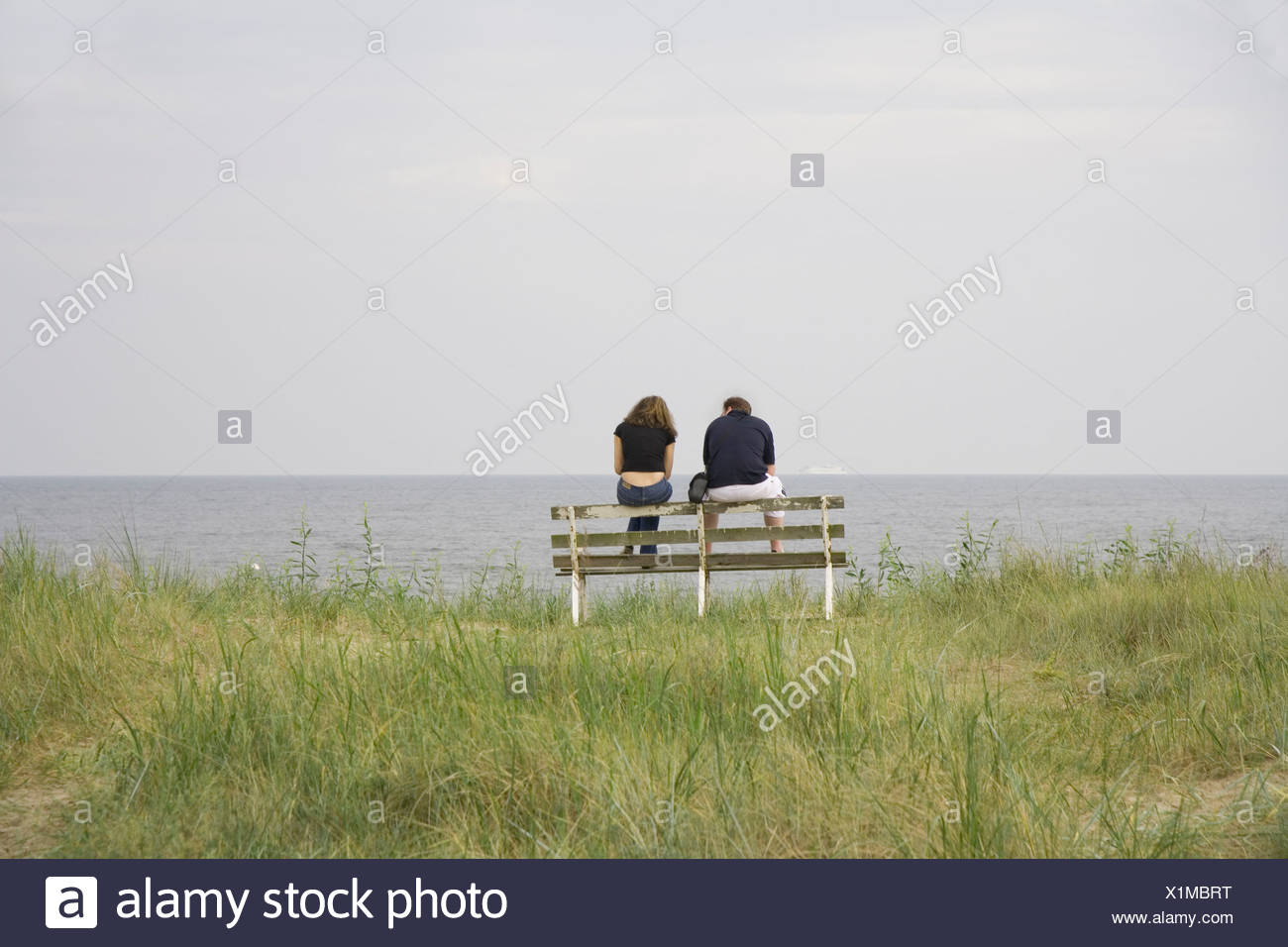 Couple On A Bank At The Baltic Sea Beach Of Ahlbeck Island Usedom