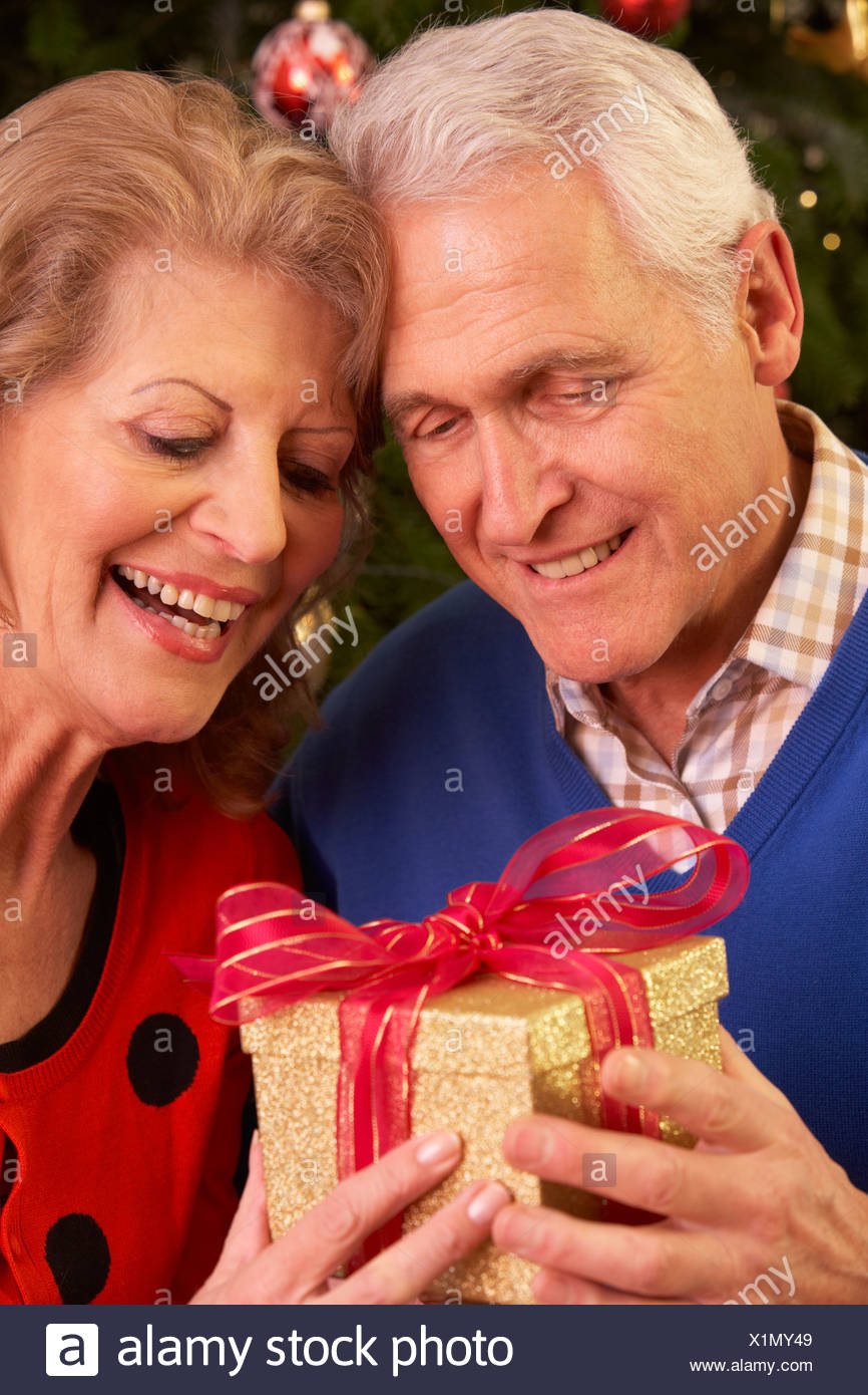 Senior Couple Exchanging Christmas Gifts Stock Photo Alamy