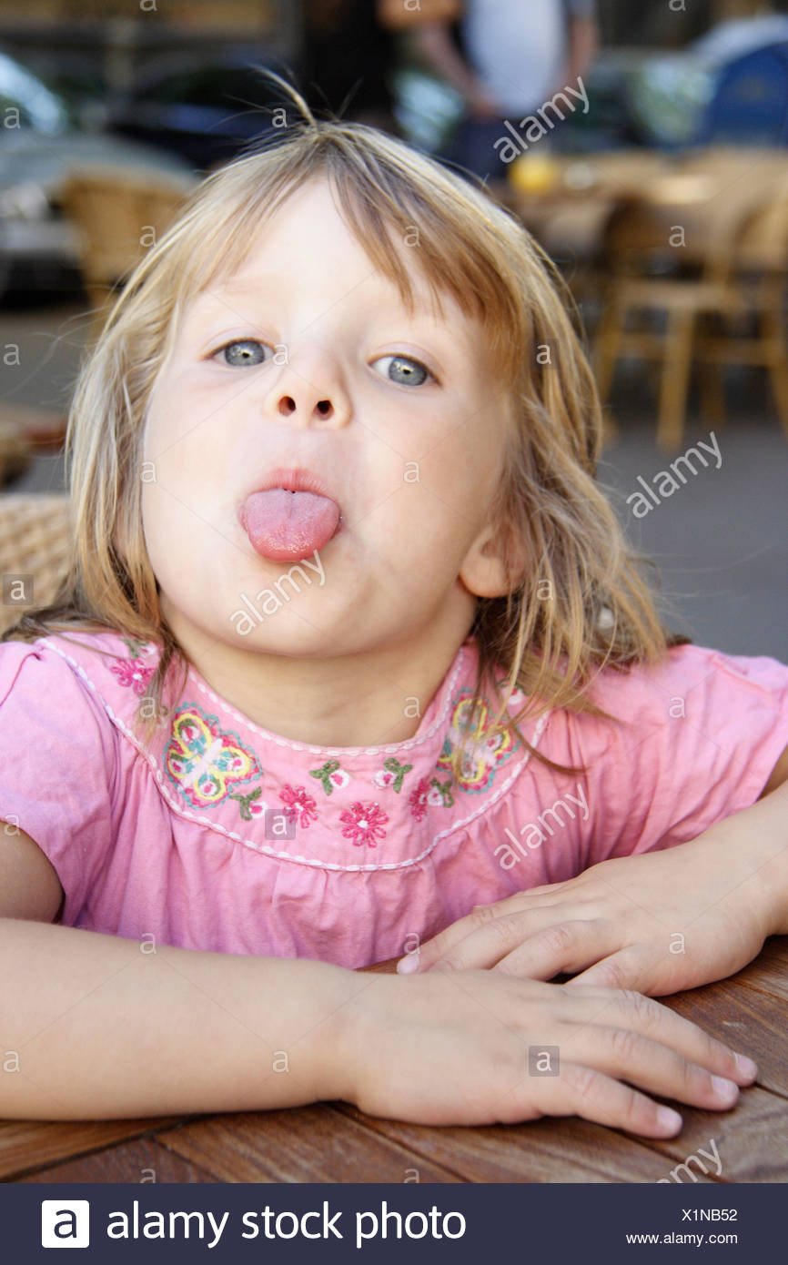 Little girl sticking her tongue out Stock Photo 276450302 Alamy