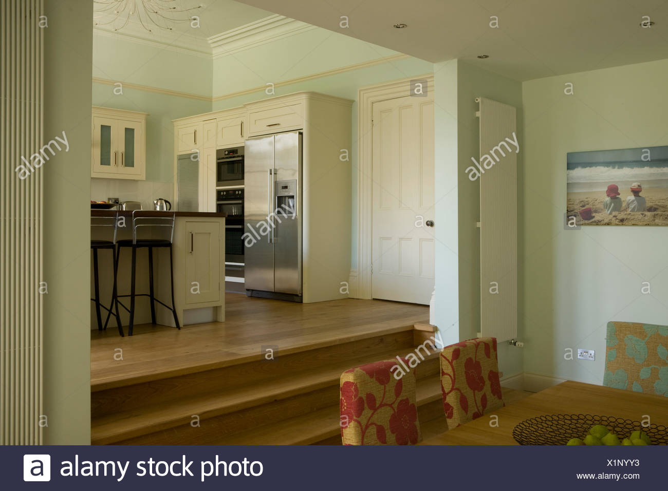 Modern Split Level Dining Room With Steps Up To Kitchen Area Stock Photo Alamy