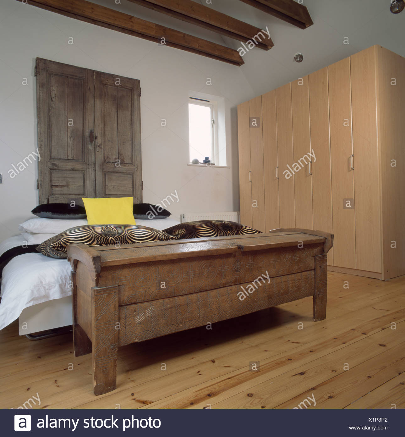 Old Wooden Cupboard Doors Above Bed In White Country Bedroom