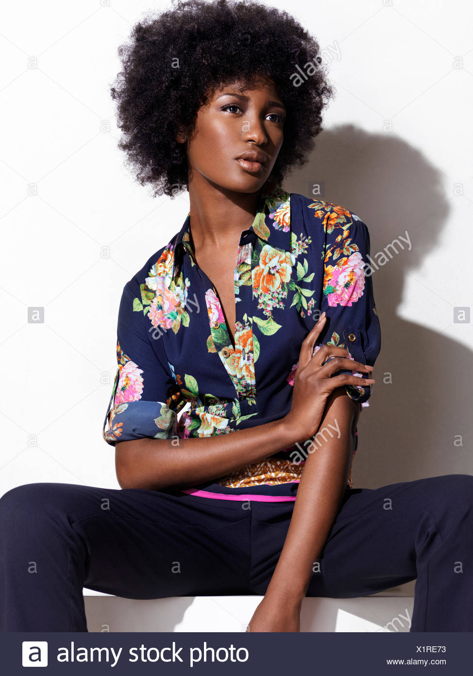 Woman Wearing A Blue Shirt With A Floral Pattern And Pants Stock Photo Alamy