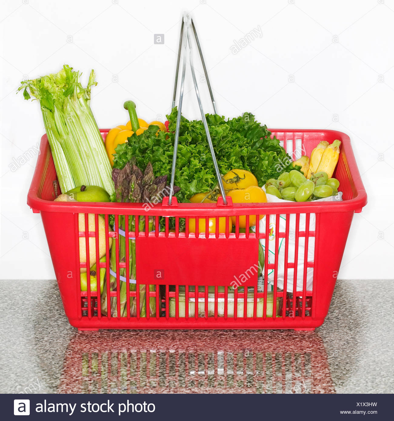 Fruits And Vegetables In Grocery Basket On Countertop Stock Photo