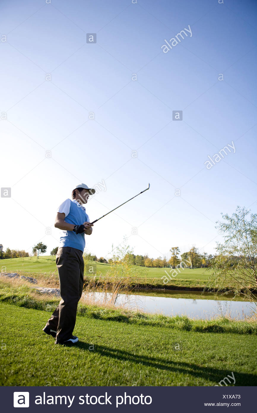 Man Swinging Golf Club On Golf Course Stock Photo 276559335