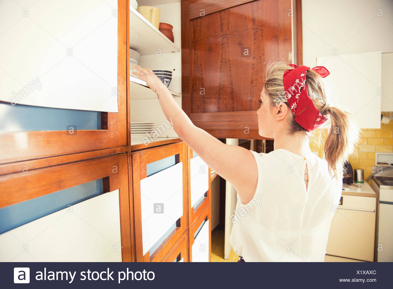 Reaching Into Cupboard High Resolution Stock Photography and Images Alamy