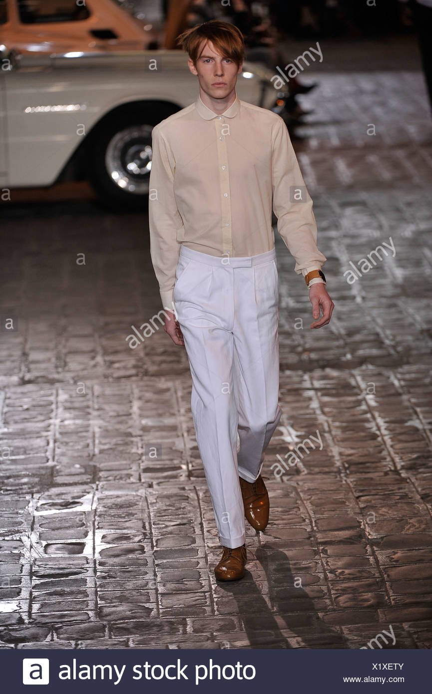 Dries Van Noten Paris Menswear Spring Summer Model wearing white trousers,  beige shirt and brown patent shoes Stock Photo - Alamy