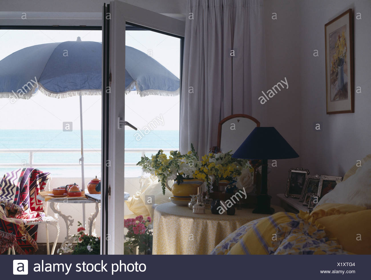 View From Bedroom Patio Doors Of Parasol With Table And Chairs On