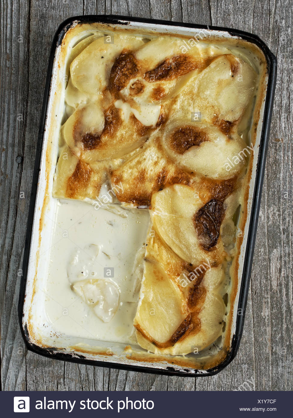 Rustic Golden Scalloped Potato Gratin Dauphinois Stock Photo
