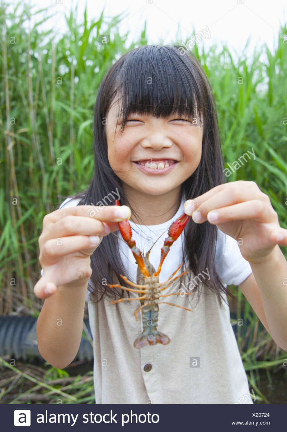 girl-holding-a-crayfish-X20724.jpg