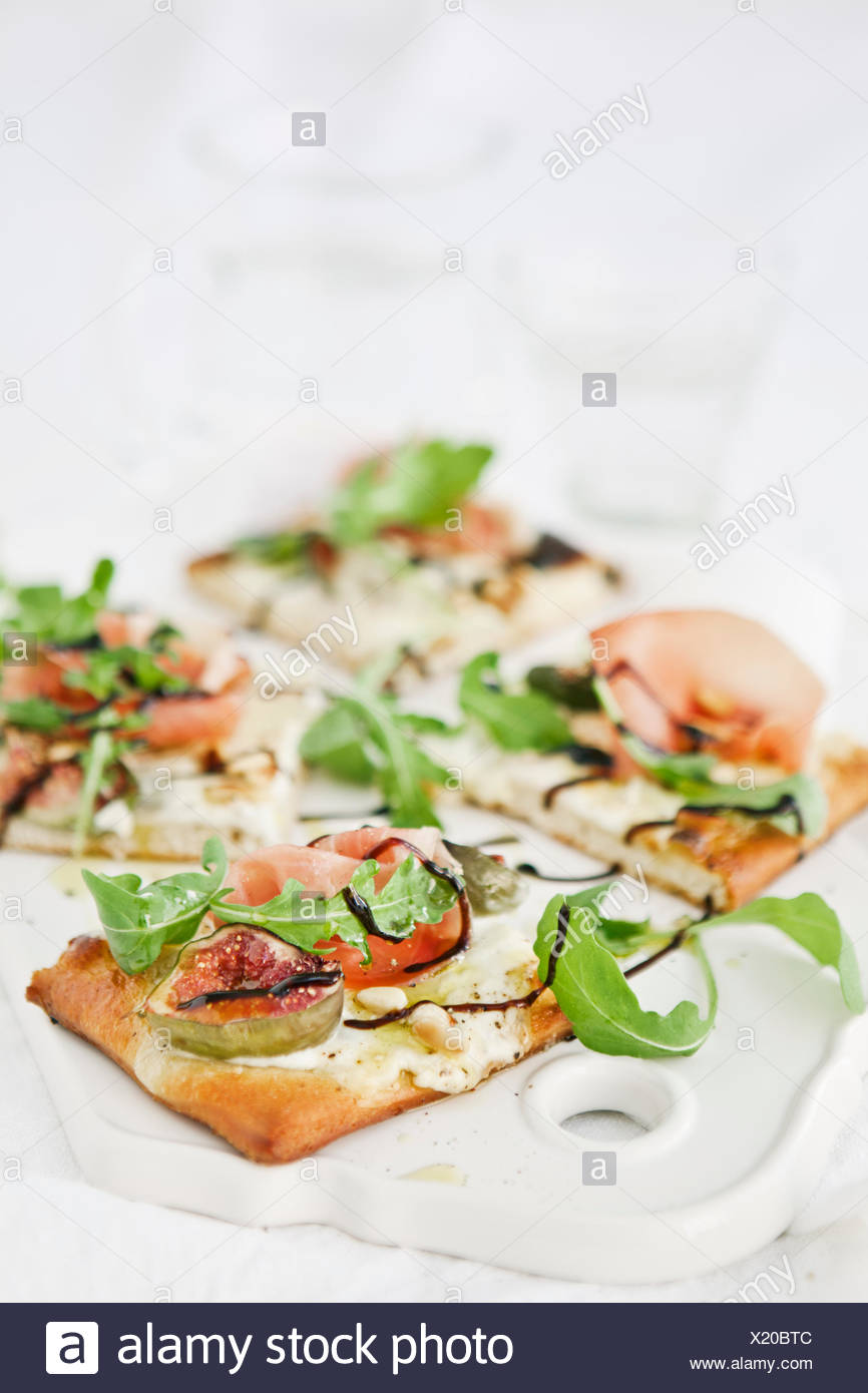 Sweden, Pizza with goat cheese cream, rocket, pine nuts, figs and ...
