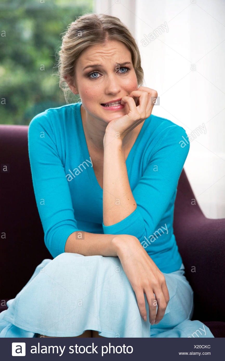 Female Blonde Hair Off Face Wearing Turqois V Neck Jumper And