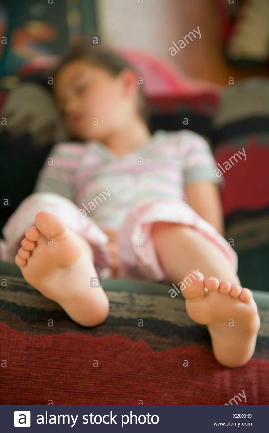 Barefoot Girl Lying On Couch Stock Photos & Barefoot Girl Lying On