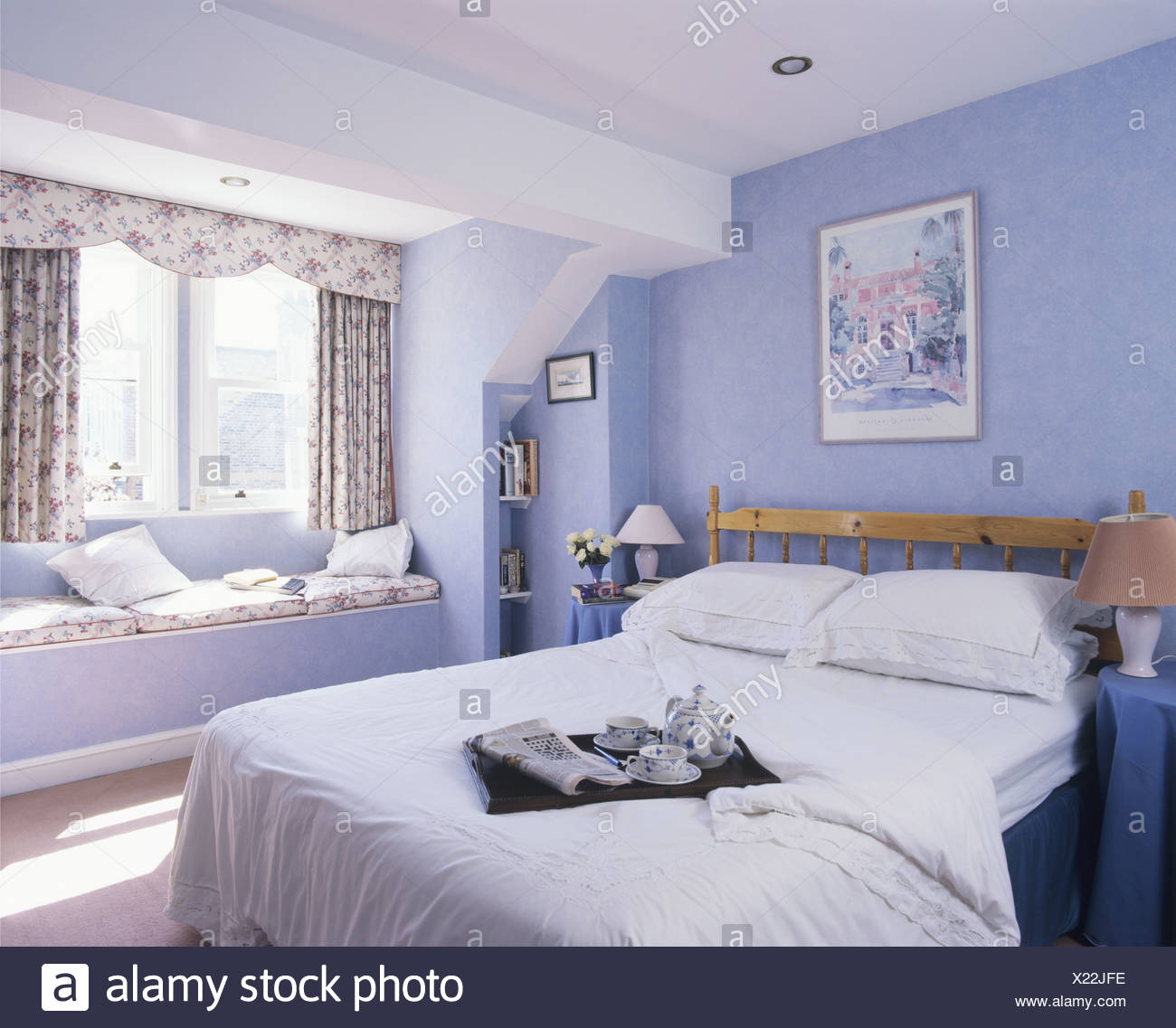 Bed With Breakfast Tray On White Quilt In Modern Pastel Blue