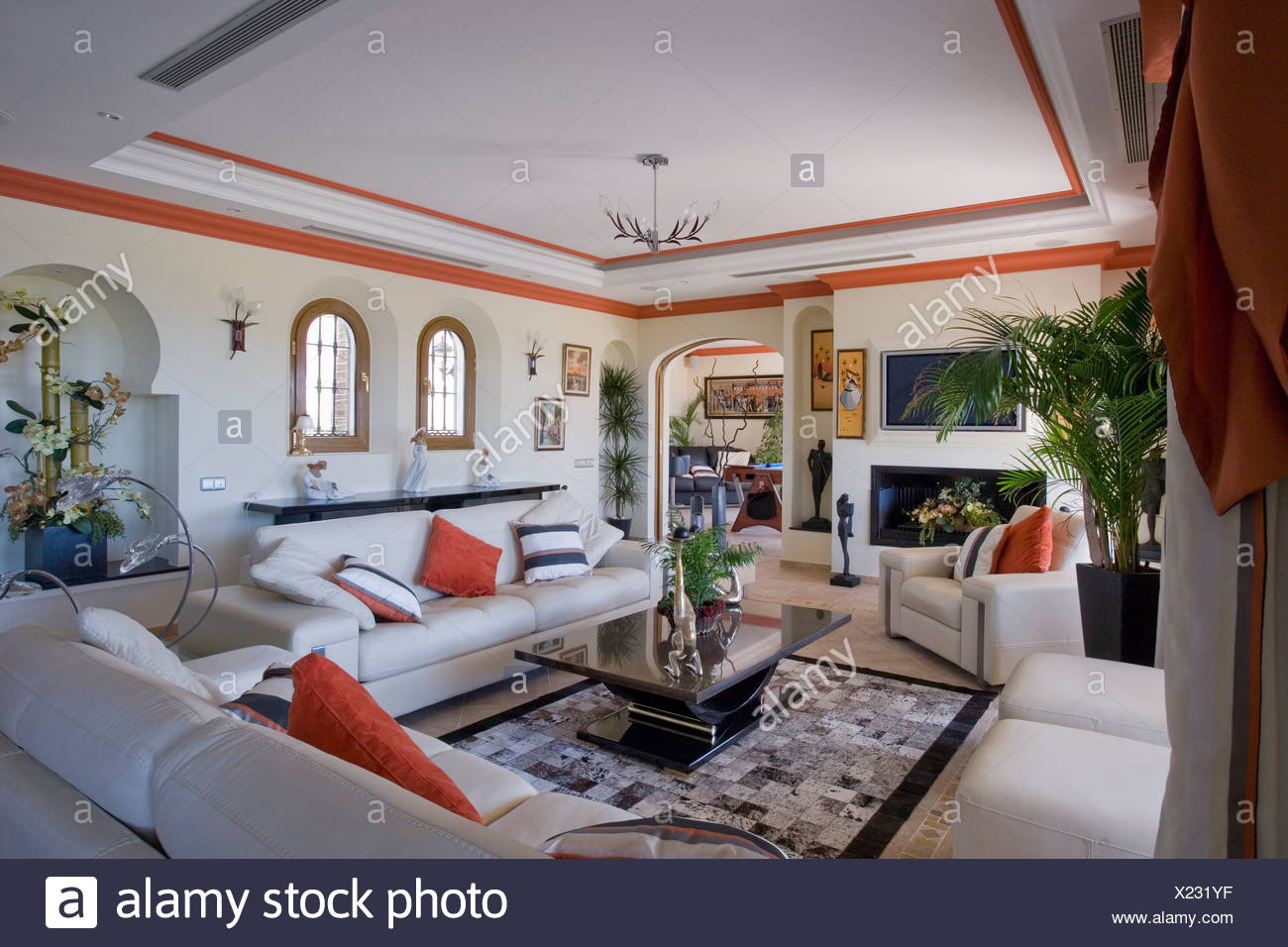 Red Cushions On White Sofas In Spanish Apartment Living Room