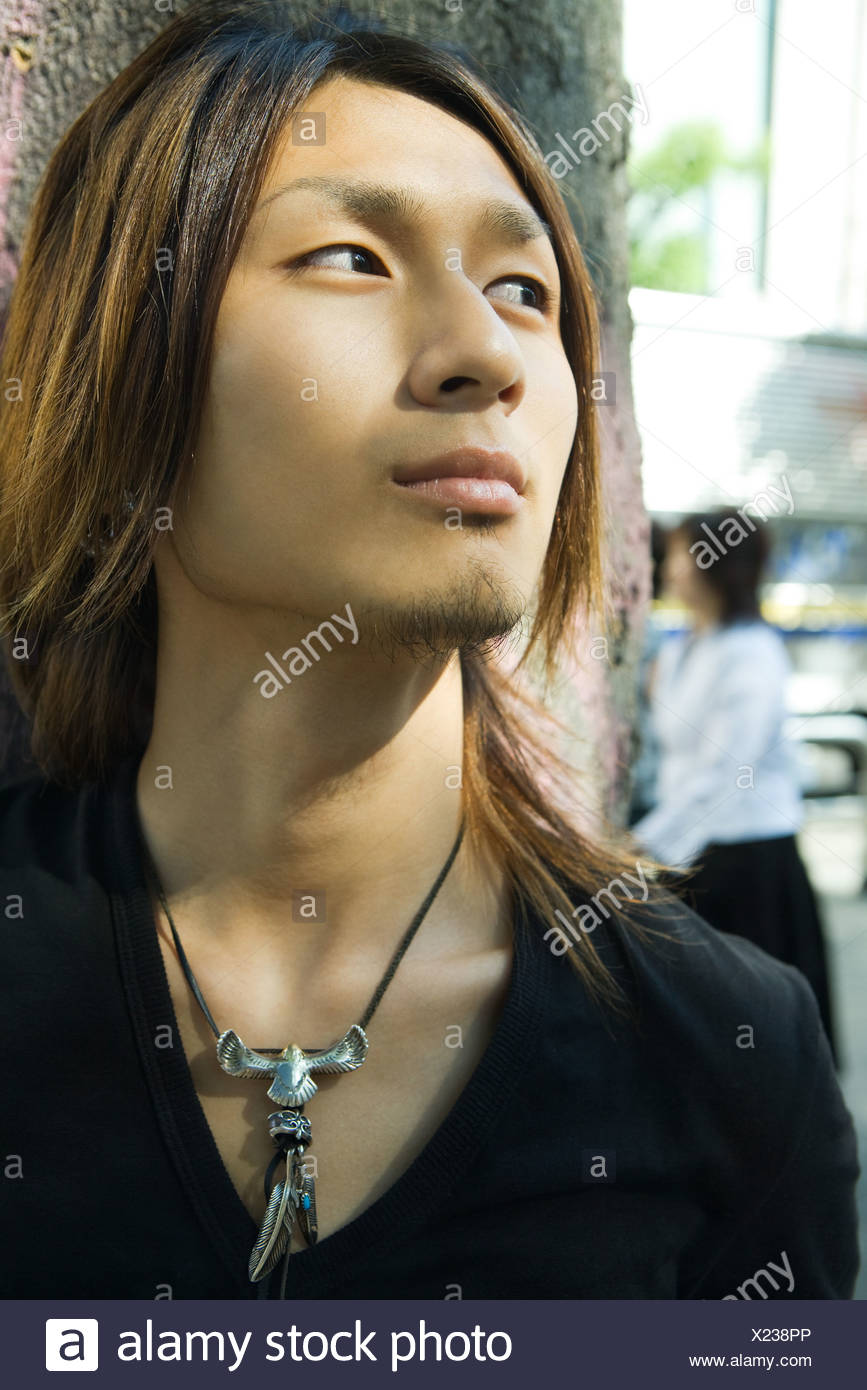 Young man outdoors, looking away, close-up Stock Photo