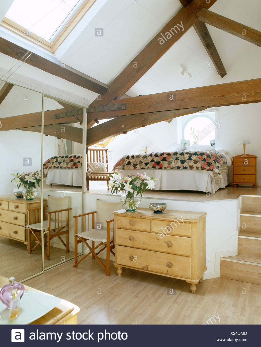 Pine Chest Of Drawers And Mirrored Wardrobe In Split Level Bedroom