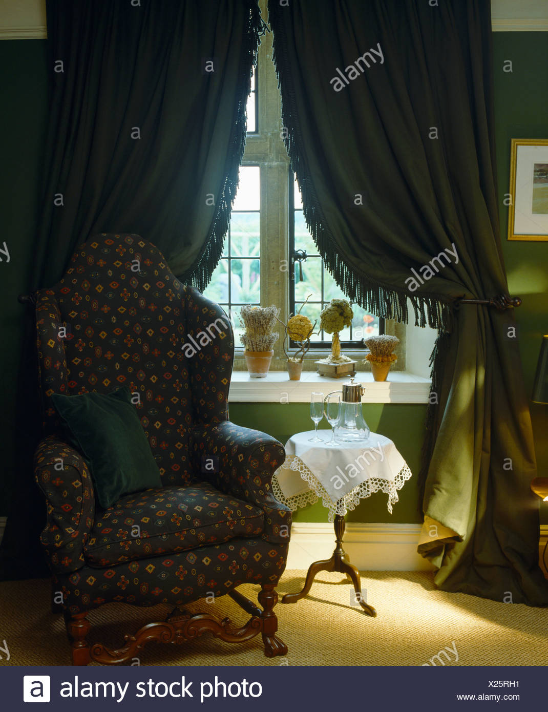 Comfortable Armchair And Small Table With Lace Cloth In Front Of