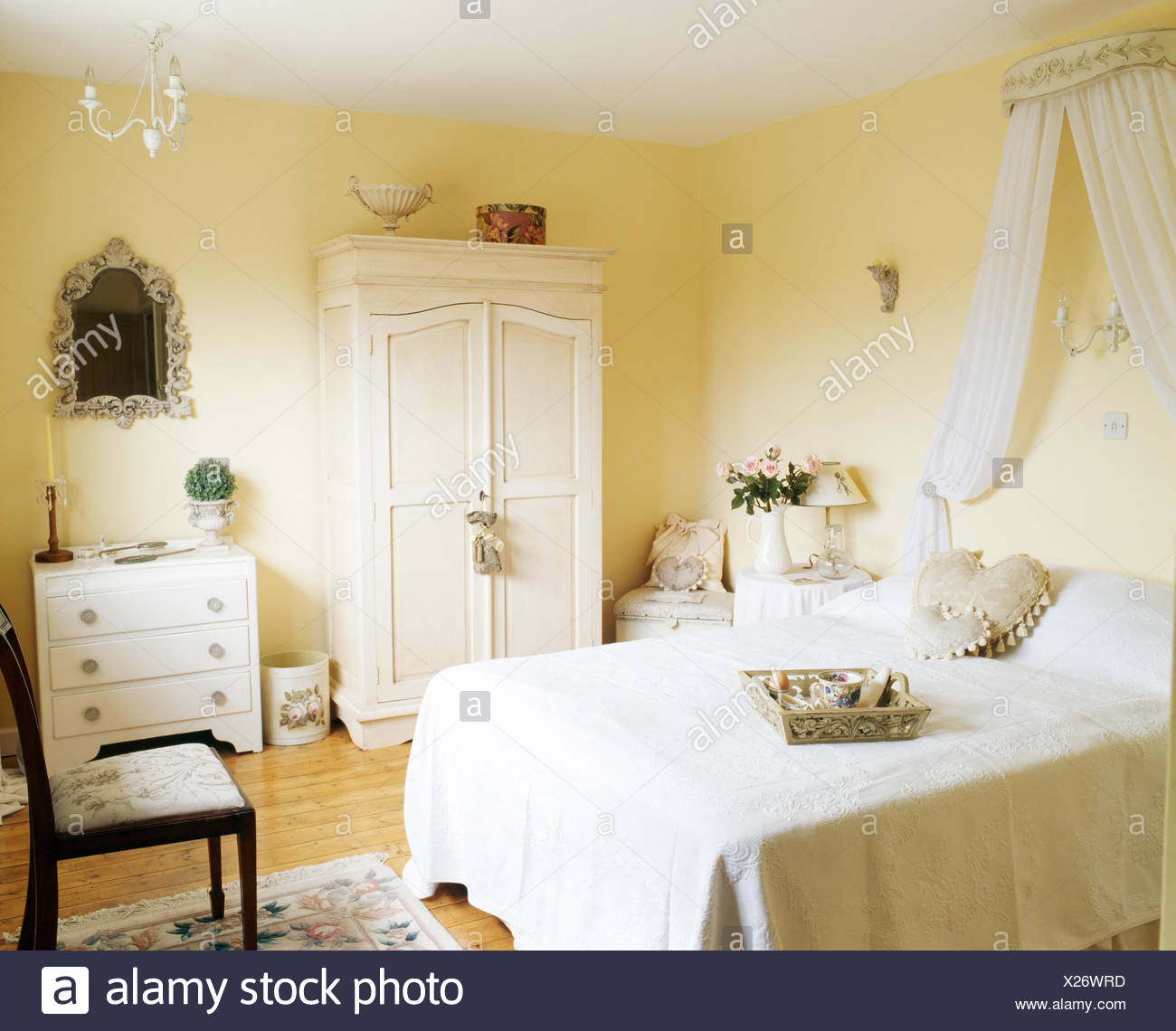 Cream Quilt On Bed With Coronet And White Drapes In Cream Bedroom