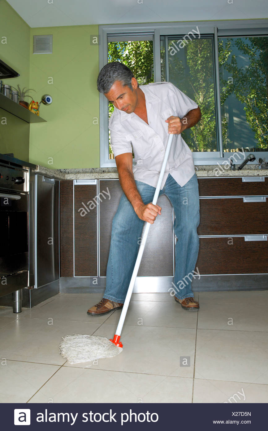 Man mopping the kitchen floor Stock Photo - Alamy
