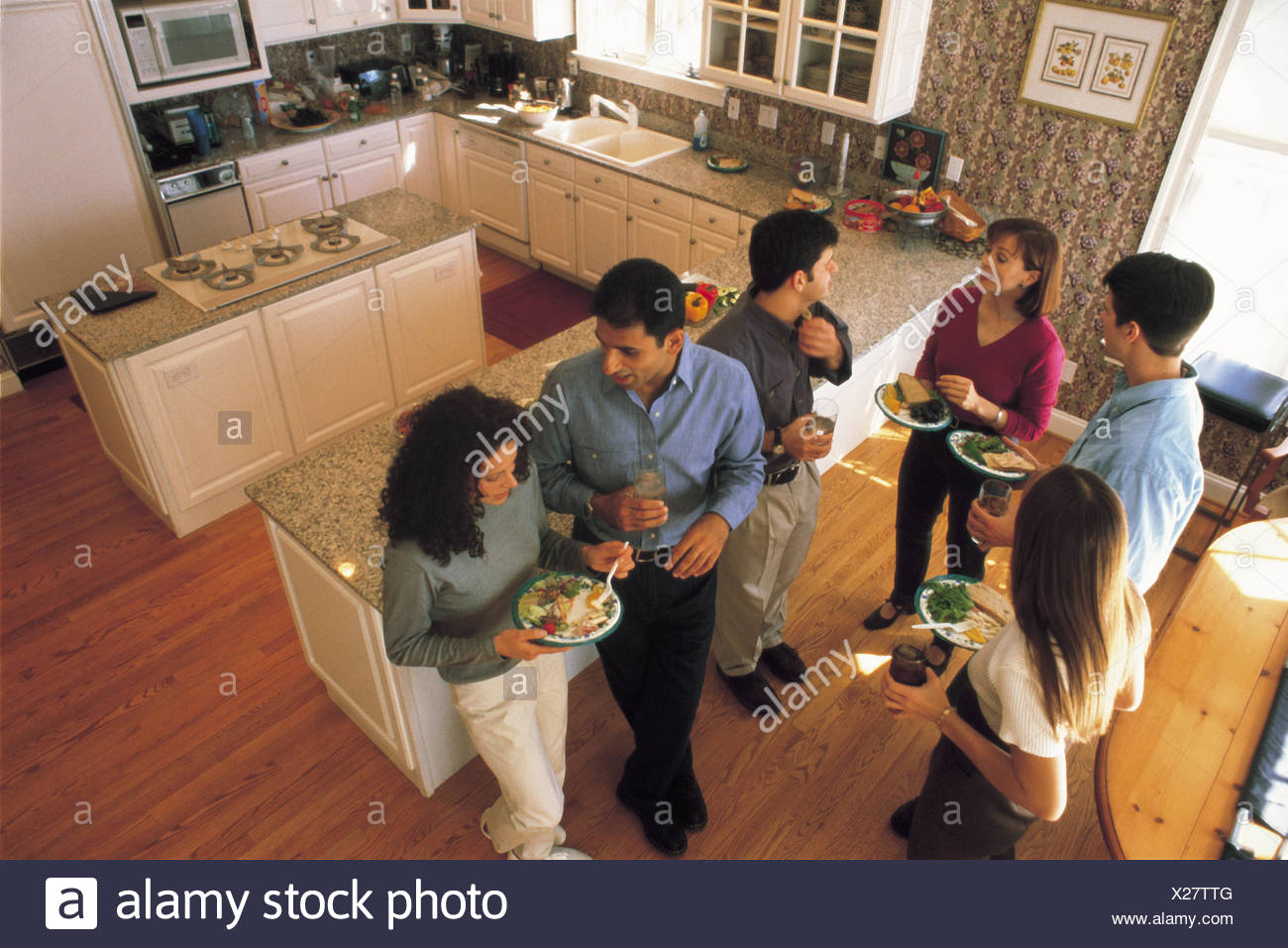 Birdseye View Of People Standing In Kitchen Eating Stock Photo Alamy