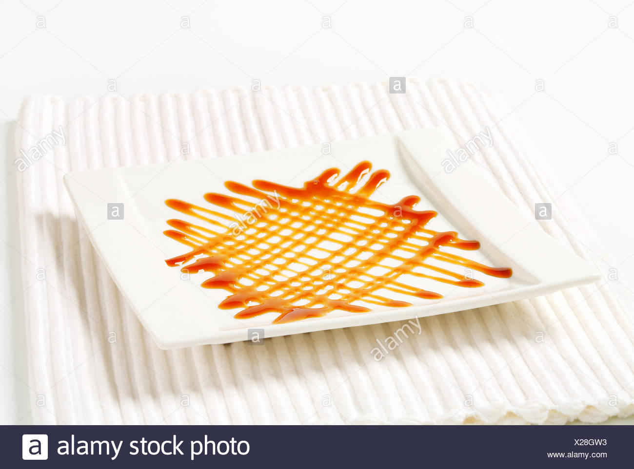Caramel Drizzle Sauce Decoration On Plate Stock Photo