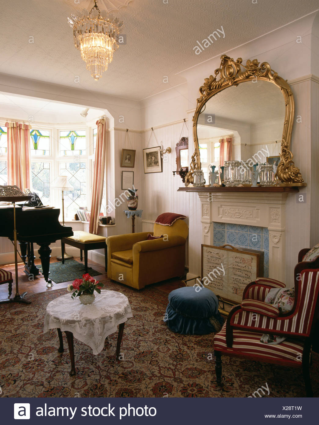 Ornate Gilt Mirror Over Fireplace In Livingroom With Piano And