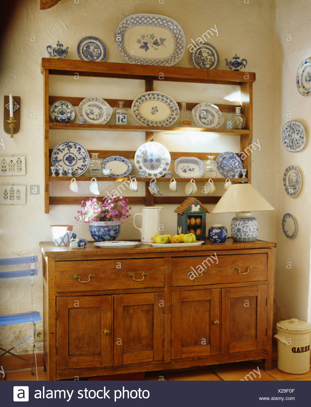 Collection Of Blue White Plates On Shelves Above Antique Pine