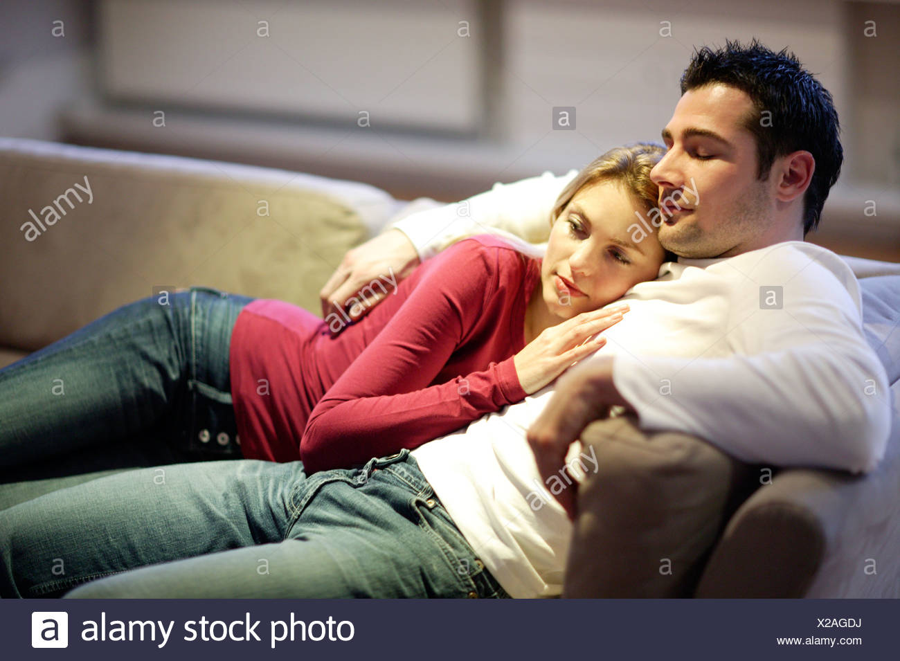 Young Couple Sleeping On Sofa High Resolution Stock Photography and