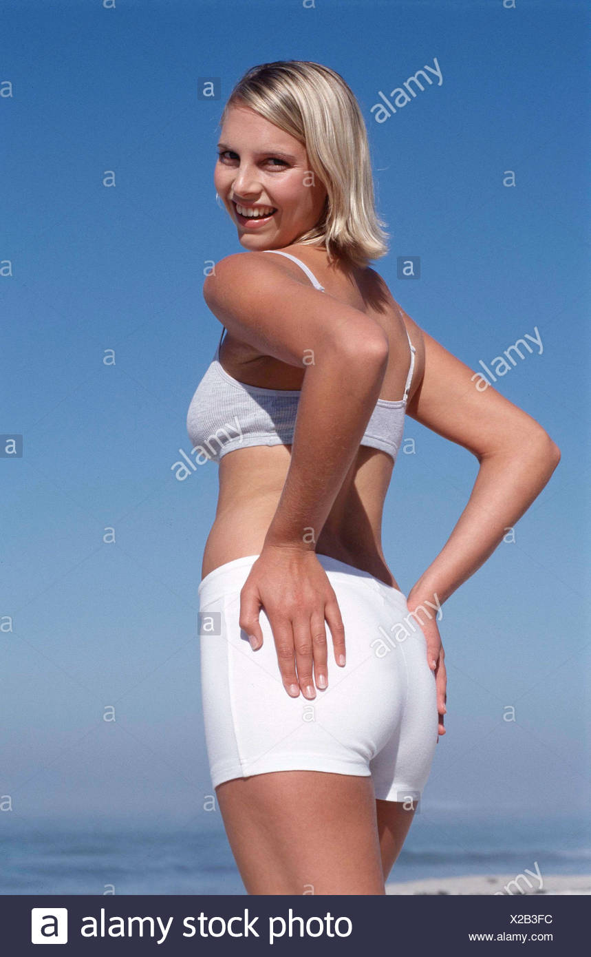 Back View Of Tanned Female Chin Length Blonde Hair Wearing Subtle