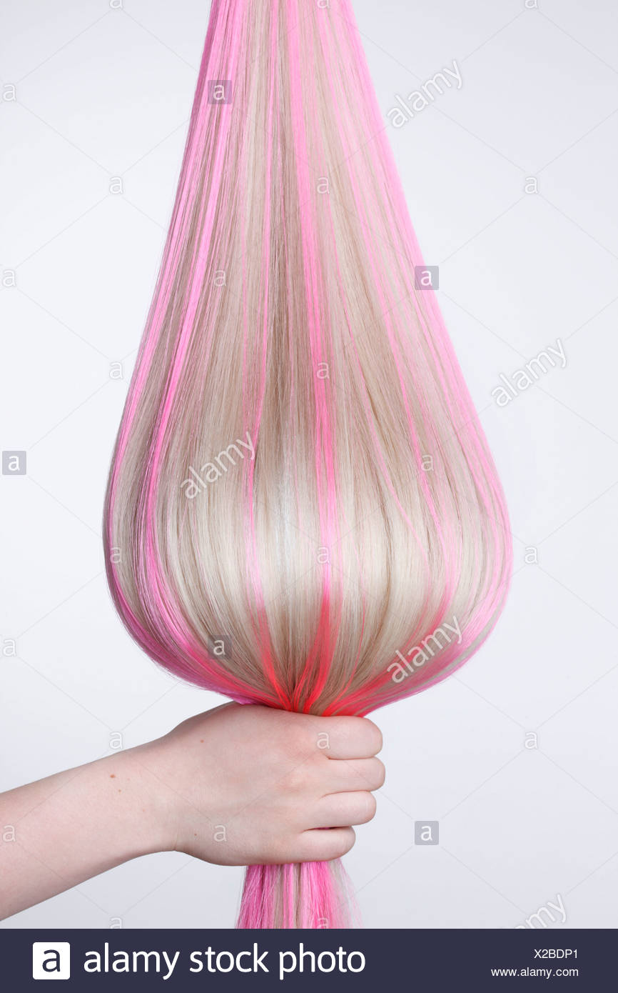 Human Hand Holding Blond Hair With Pink Highlights Against White