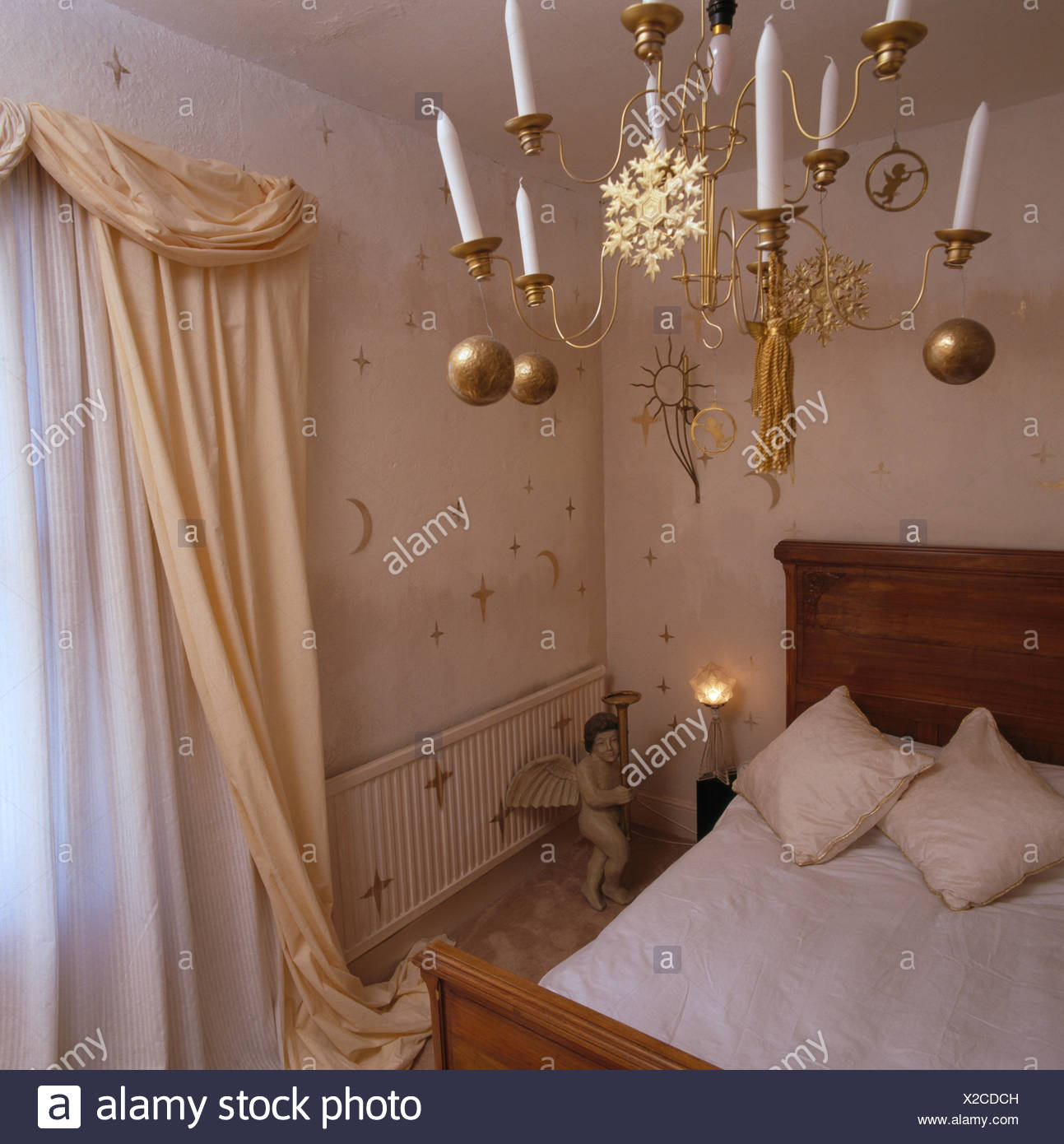 Candles In Brass Chandelier Decorated With Gold Baubles In