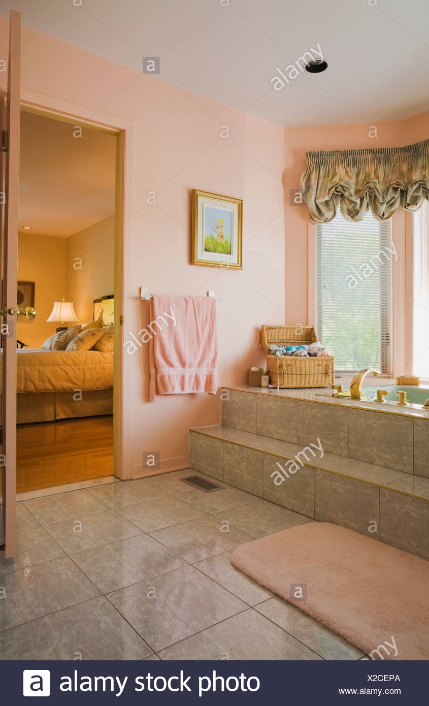 Bathroom With Opened Door Leading To The Master Bedroom In A