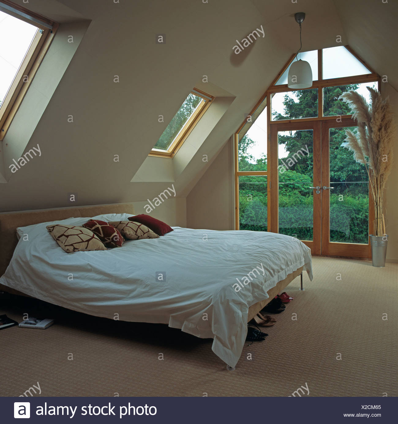 Brown And Cream Cushions With White Duvet On Bed In Modern