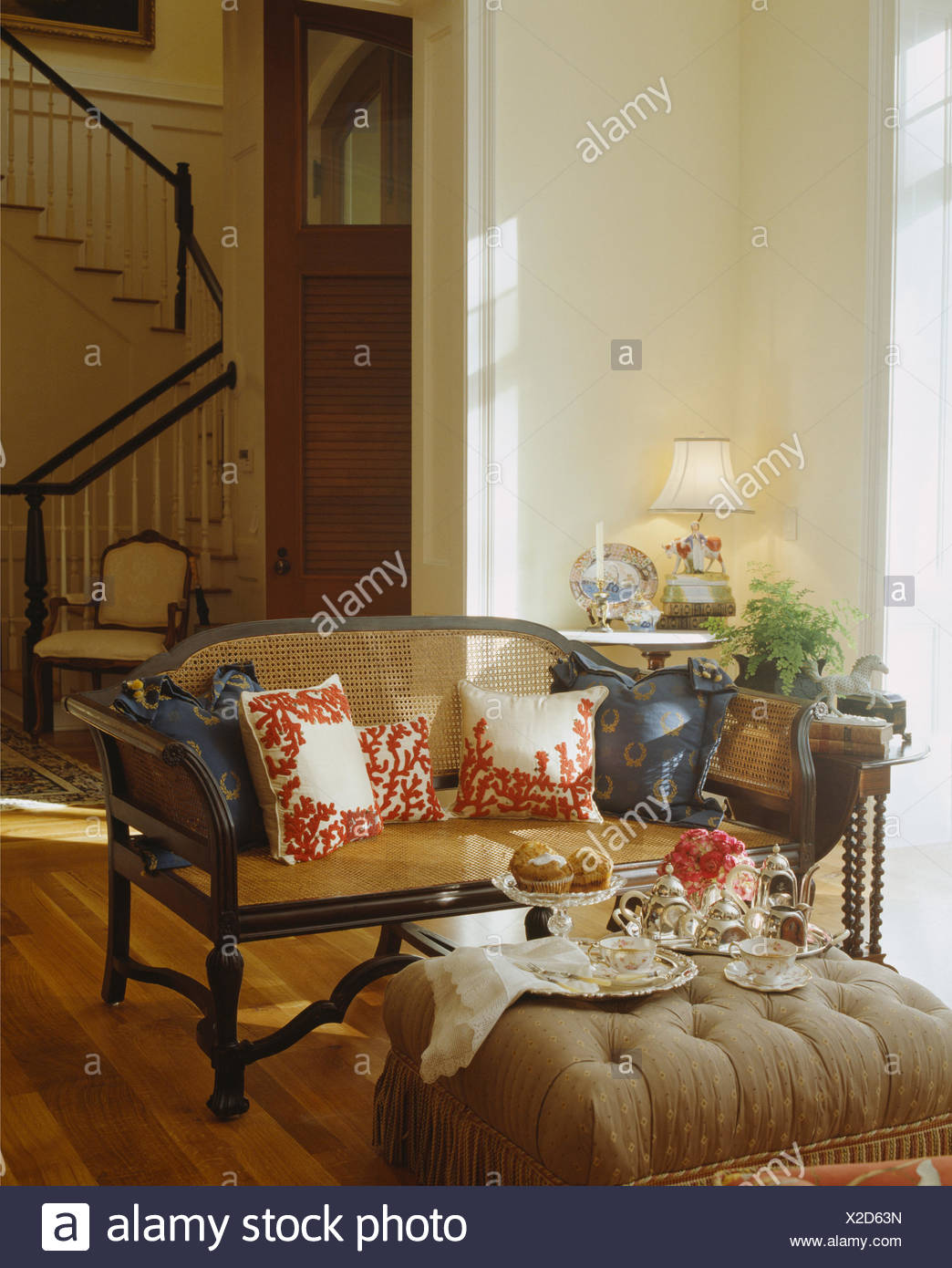 Tea Set On Upholstered Stool In Front Of Antique Bergere