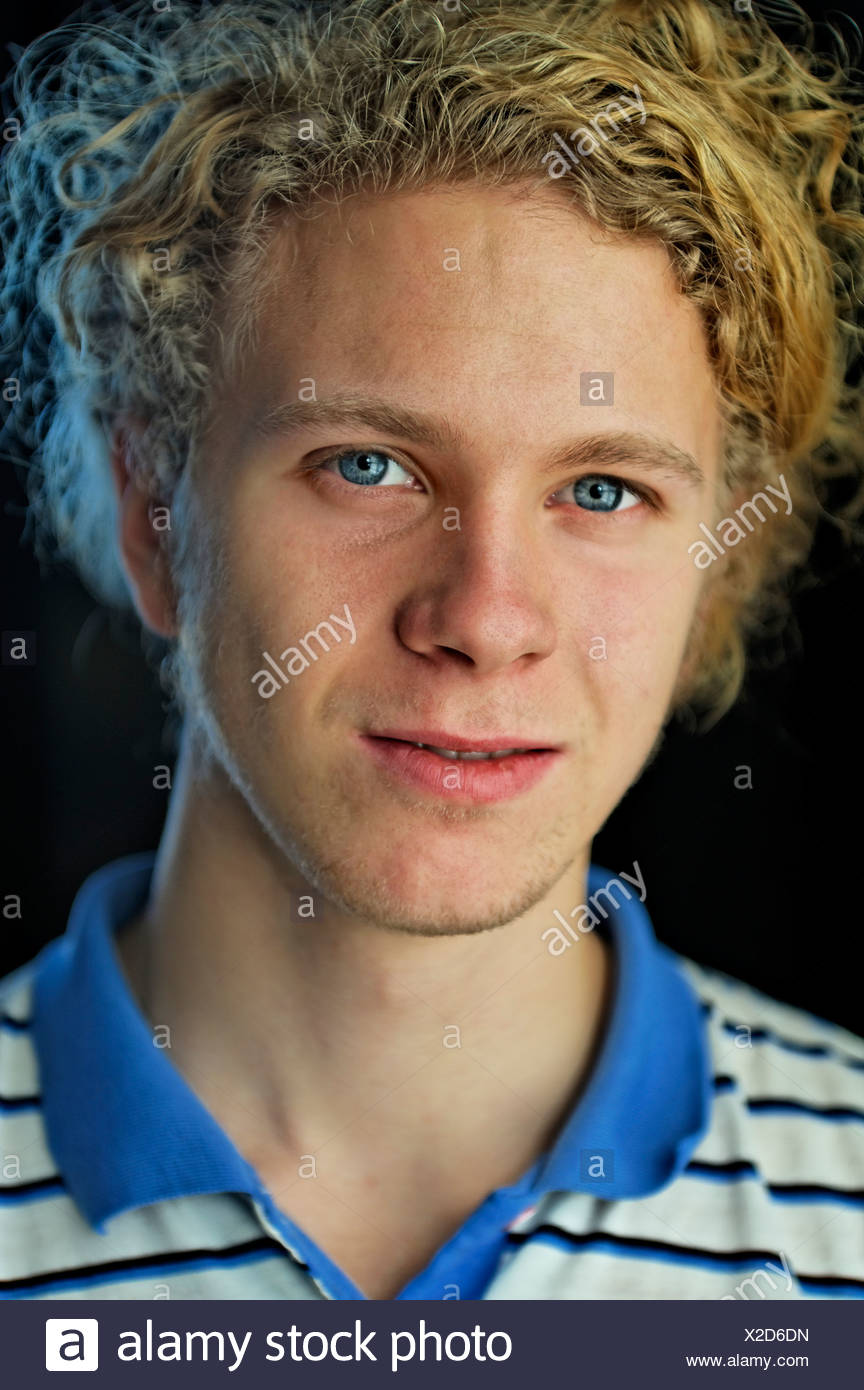 Close Up Portrait Of A Blond Teenage Boy With Blue Eyes Stock
